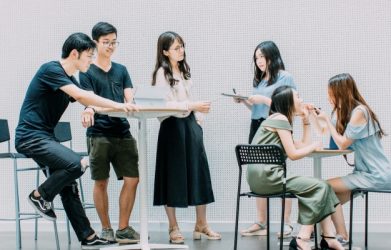 Young adults chatting at high and low tables
