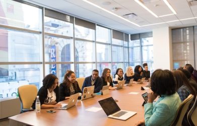 Business team meeting in conference room with laptops